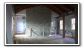 Second Floor - Interior of the old Holbrook Mill. <br>Reclaimed hardwood floors, stone interior walls and exposed trusses highlight the open-ceiling of the mill's second floor (residential) living space.